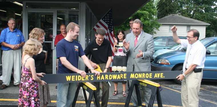 Ned Green and others during the opening board cutting ceremony at Weider's Paint and Hardware in Brighton