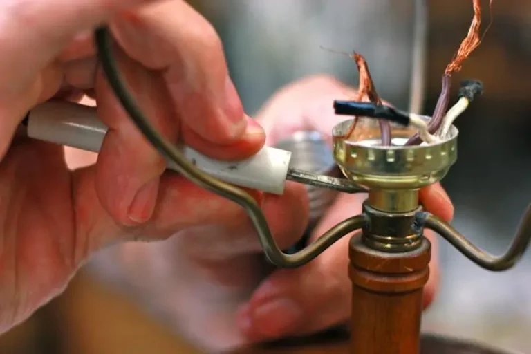 a technician repairing a lamp socket