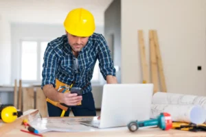 a handyman at a work station looking at plans