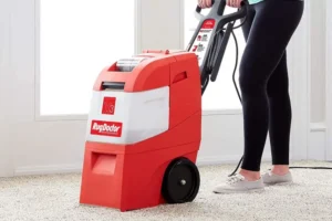 a person using a rug doctor carpet cleaner